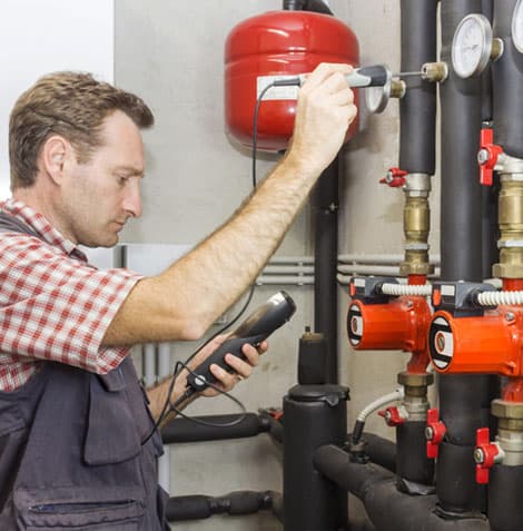 Gas engineer inspecting a boiler